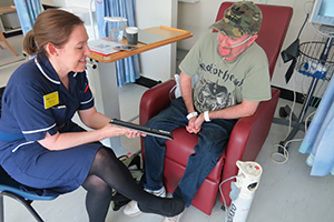 Clare Denny, senior sister outpatients, talks to a patient at one of the Trust's new cardiology day case facilities 