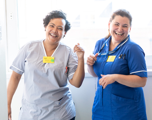 Nurses laughing in corridor