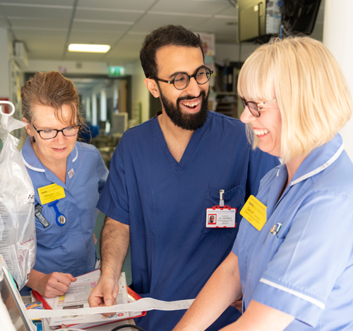 Nurses around machinery