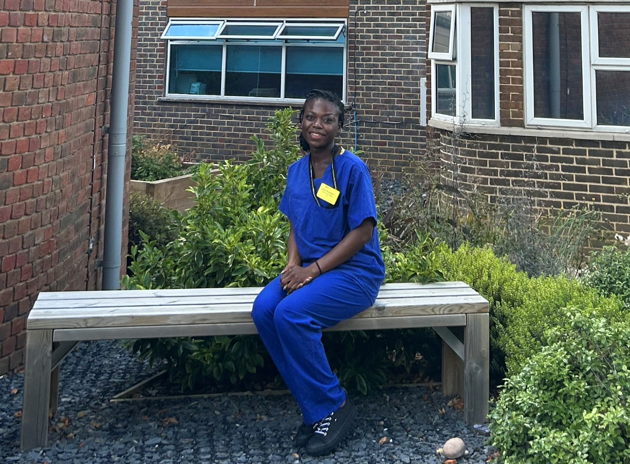 Image of Priscilla Bekoe in uniform and sitting on a bench
