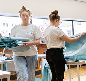 PPE volunteers folding completed gowns