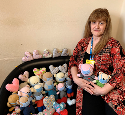 Rosa Osborne with some of the knitted hearts and teddies