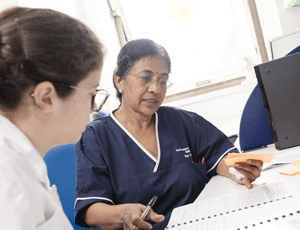 Two healthcare professionals looking at documents