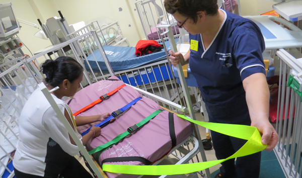 Paediatric nurses preparing a ski sheet for evacuation 