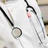 Zoomed in image of faceless person wearing a stethoscope and white coat
