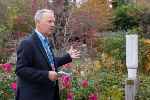 Dr Richard Grocott-Mason speaking and pointing at the Harefield Hospital Pillar of Tranquility