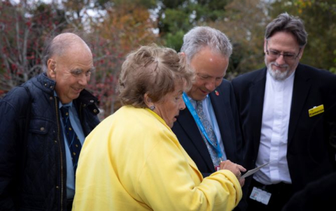 Jane Sommerville showing a picture of first operation to Dr Richard Grocott-Mason, Rev Cameron Barker and Robert Parker