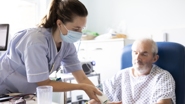 A nurse with a patient on a ward